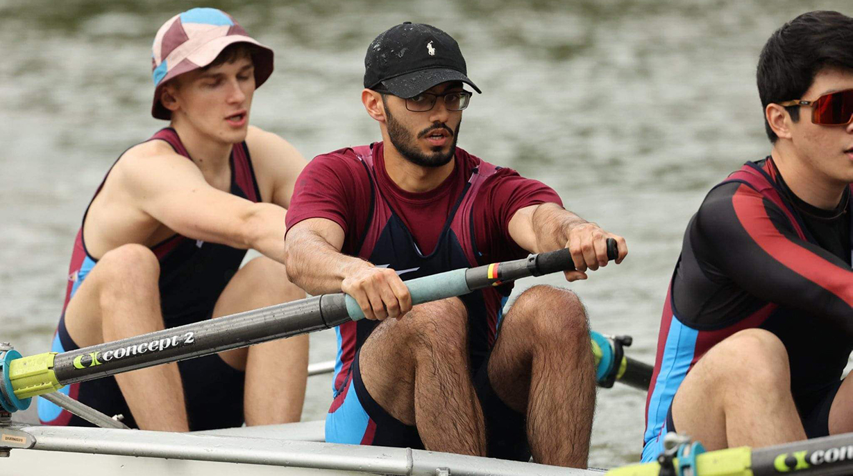 A close-up of the men's boat club rowing on the river