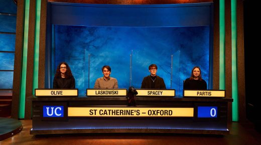The four Catz students sit behind the University Challenge desk. Their surnames are Olive, Laskowski, Spacey and Partis. 'St Catherine's - Oxford' appears on the front of the desk.